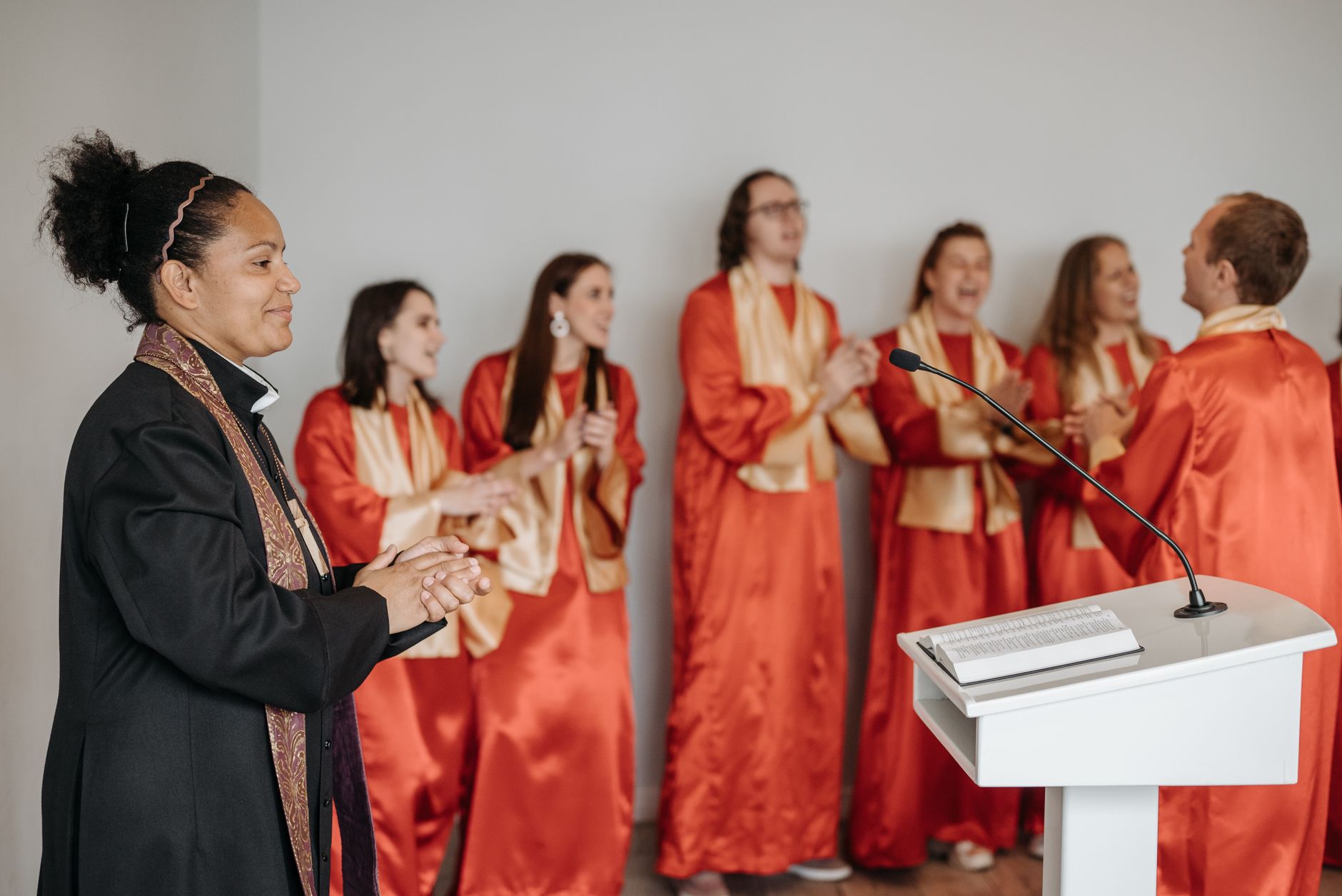 A church choir and pastor leading worship together