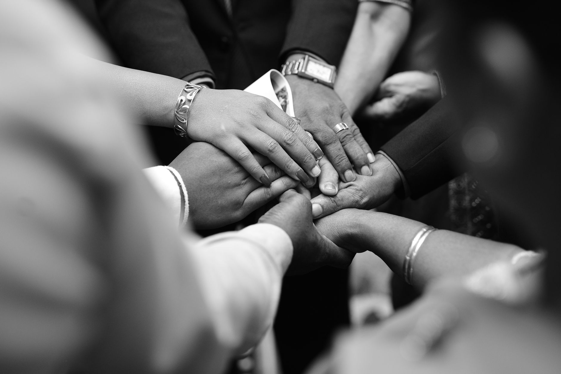 A close-up photo of diverse hands united together, symbolizing spiritual unity
